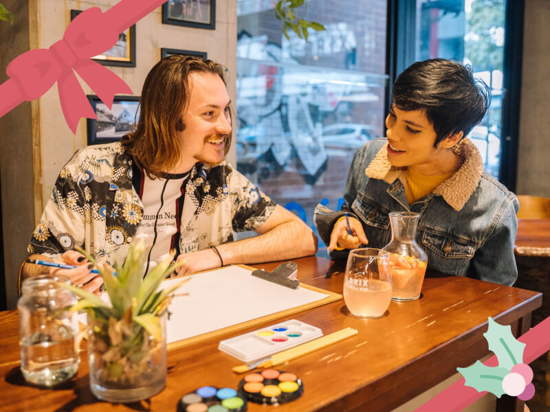 couple smiling at paint and sip class